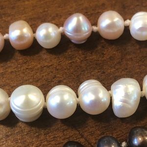 Three strands of natural pearls. Black pink white